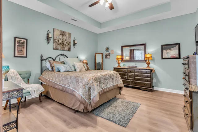 a bedroom with a bed and a lamp on table