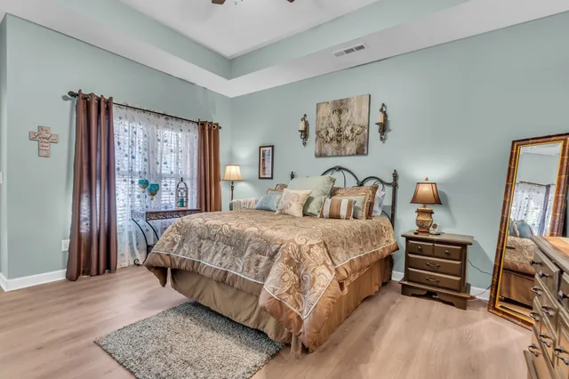 a bedroom with a bed and a large mirror