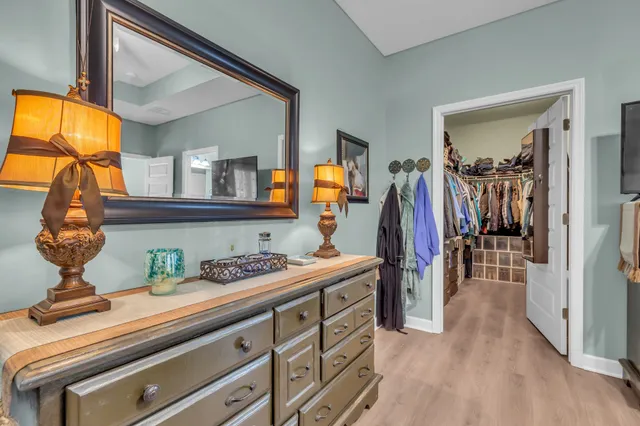 a view of a hallway with wooden floor and entryway