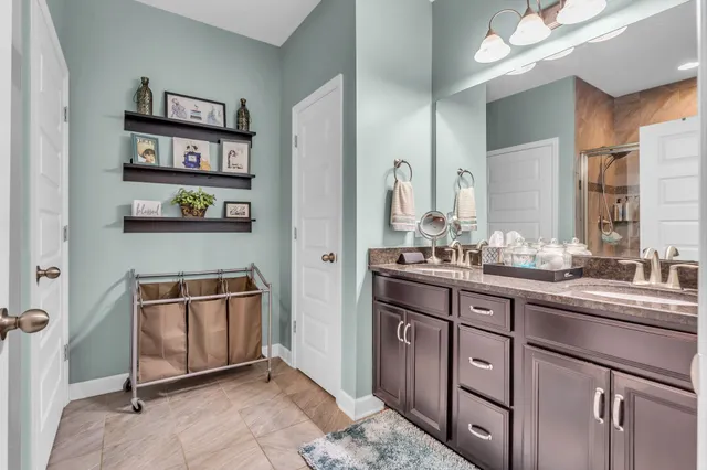 a spacious bathroom with a sink a toilet and a mirror
