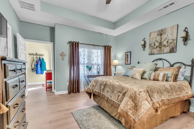 a bedroom with a bed and a chandelier