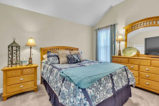 a bedroom with a bed and a dresser