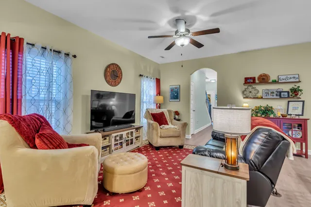 a living room with furniture and a flat screen tv
