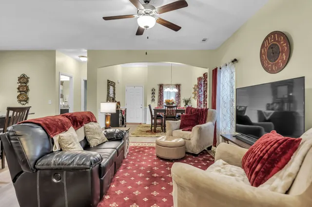 a living room with furniture and a chandelier