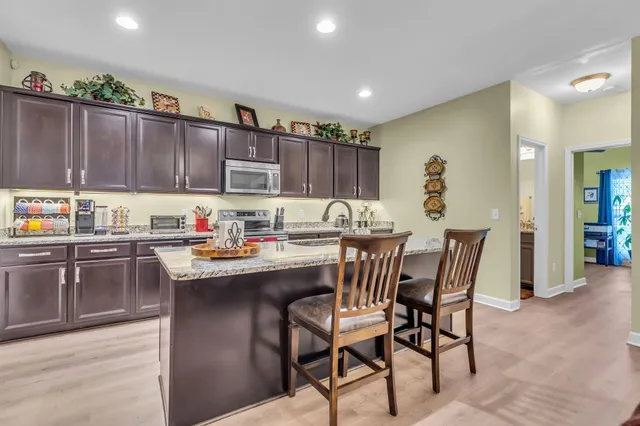 a kitchen with kitchen island a sink table and chairs