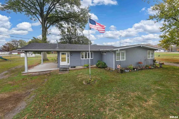 a backyard of a house with table and chairs