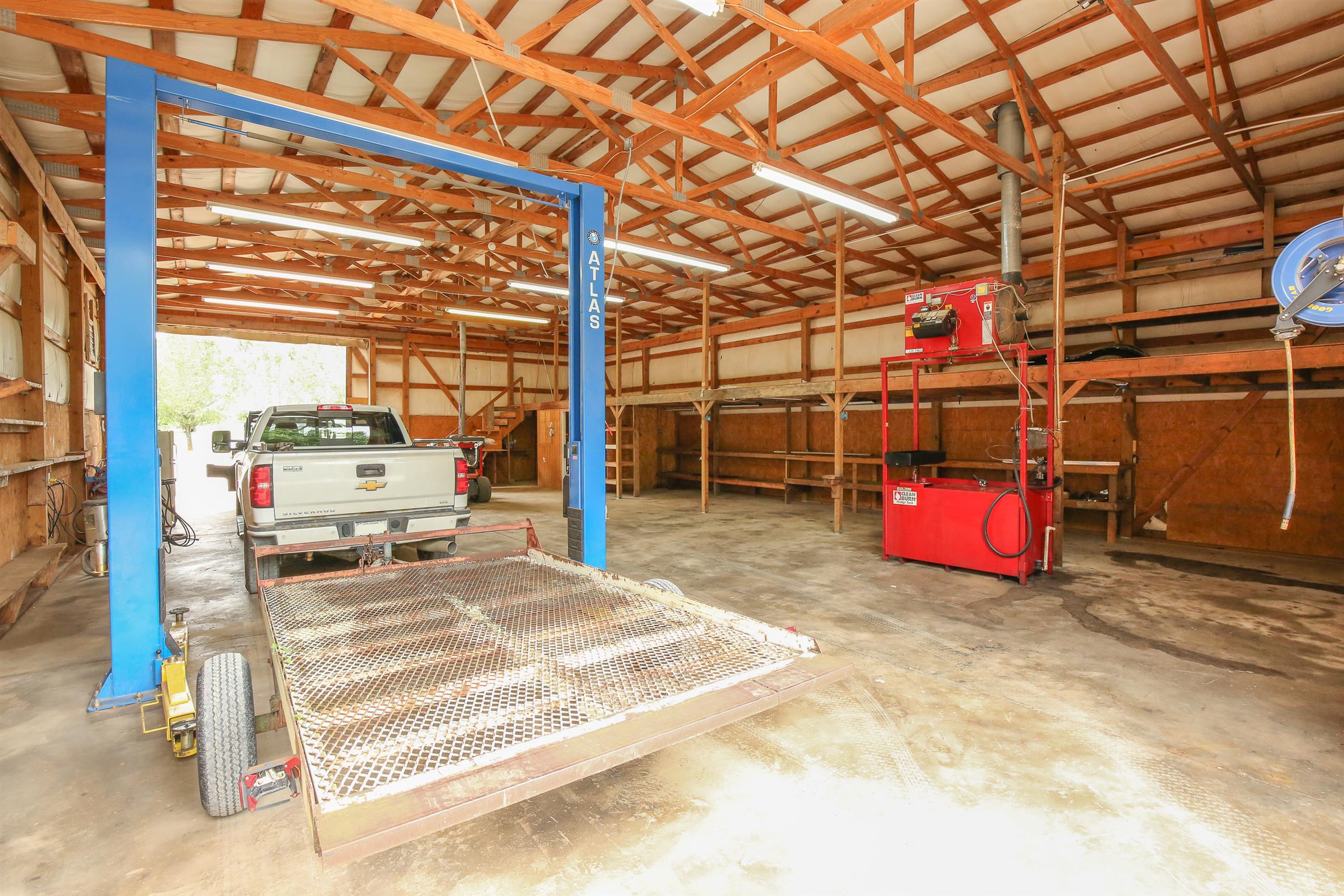3411 East Compton Road Murfreesboro, TN 37130 - Photo 4 of 30 Inside the barn a 10,000 LB 2 Post Carlift, Clean Burn oil heat system(the red equipment), high capacity air compressor