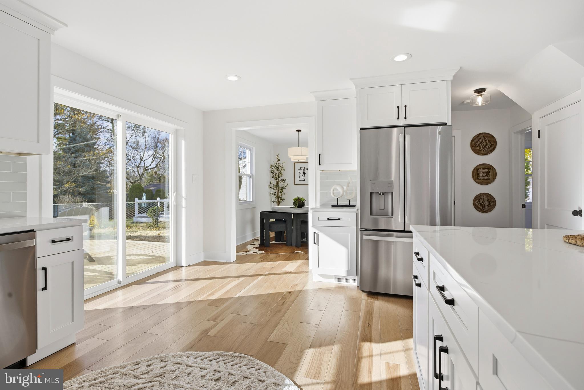 338 Wayne Avenue Springfield, PA 19064 - Photo 11 of 34 a large white kitchen with granite countertop a sink and a refrigerator