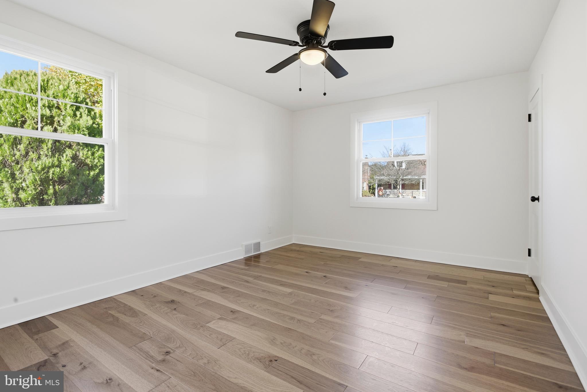 338 Wayne Avenue Springfield, PA 19064 - Photo 14 of 34 a view of empty room with wooden floor and fan