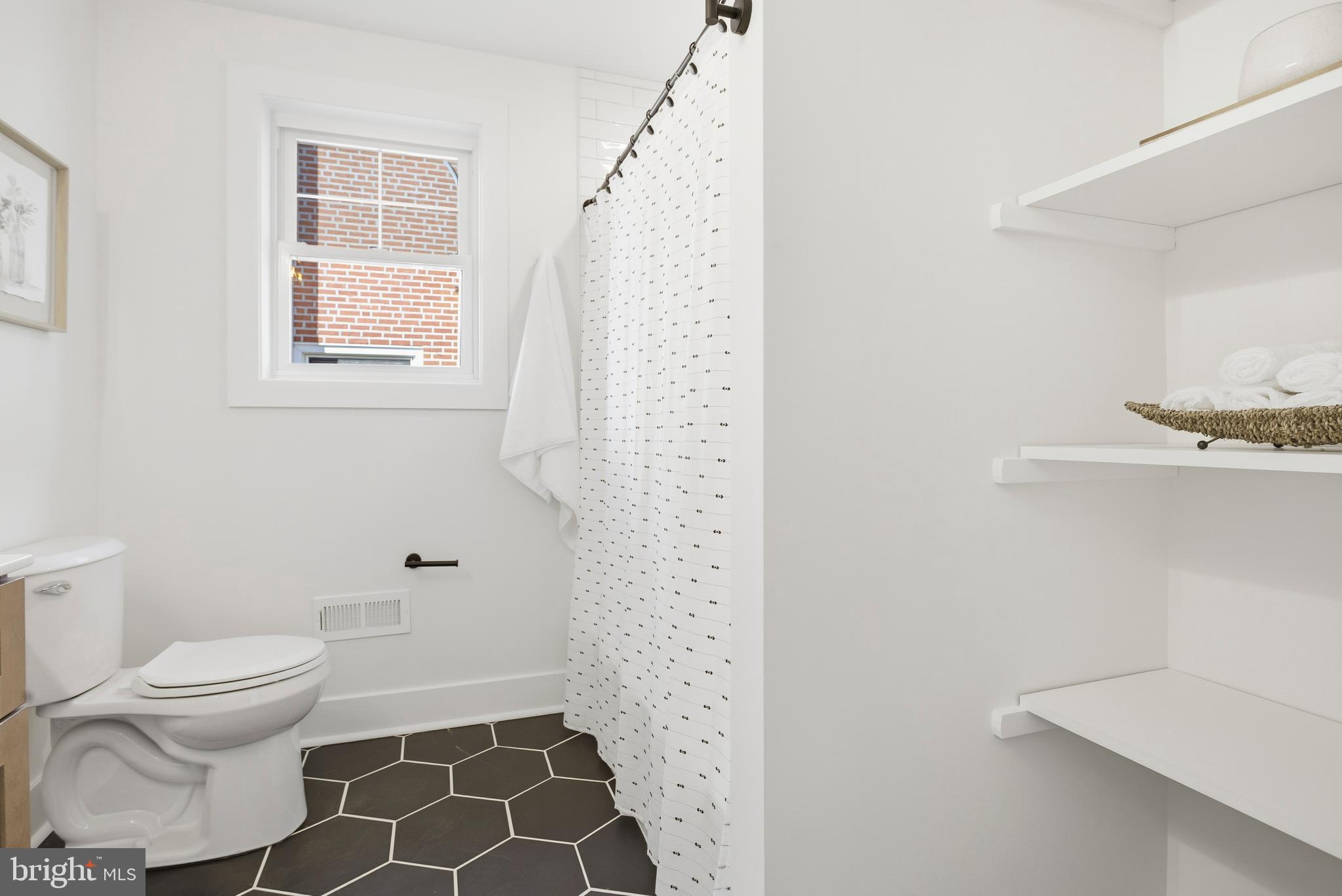338 Wayne Avenue Springfield, PA 19064 - Photo 17 of 34 a white toilet sitting next to a bathroom sink