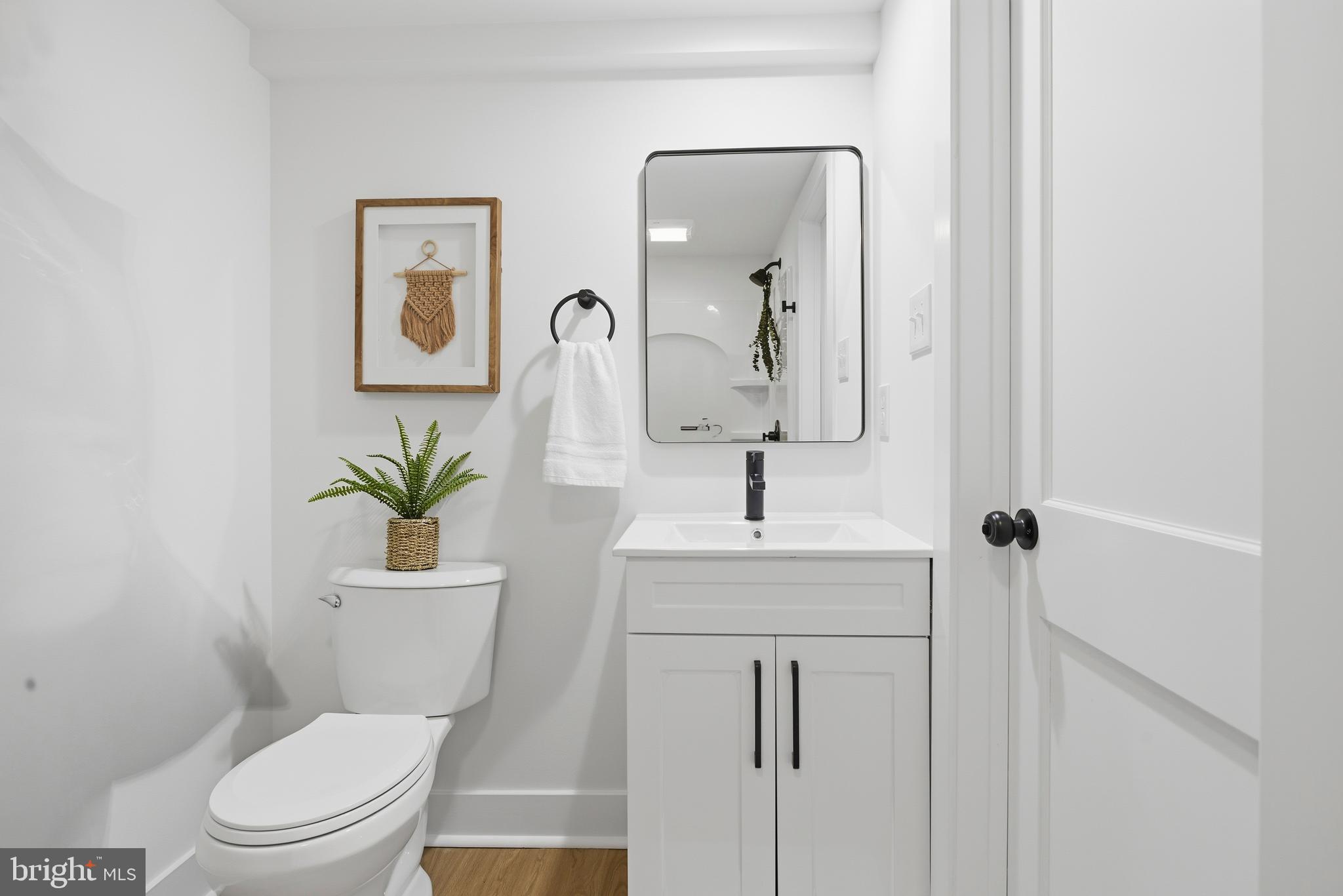 338 Wayne Avenue Springfield, PA 19064 - Photo 27 of 34 a bathroom with a toilet a sink and mirror