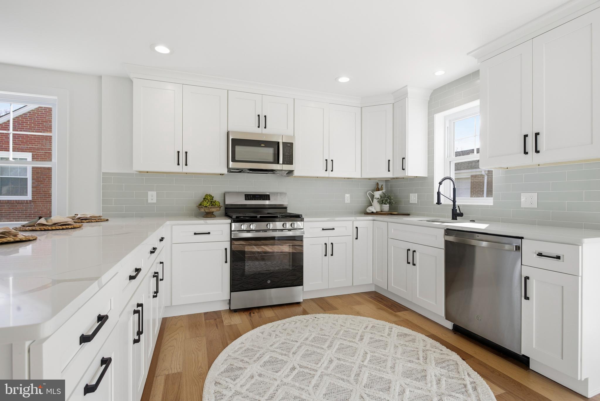338 Wayne Avenue Springfield, PA 19064 - Photo 8 of 34 a kitchen with stainless steel appliances granite countertop a sink a stove a refrigerator and cabinets