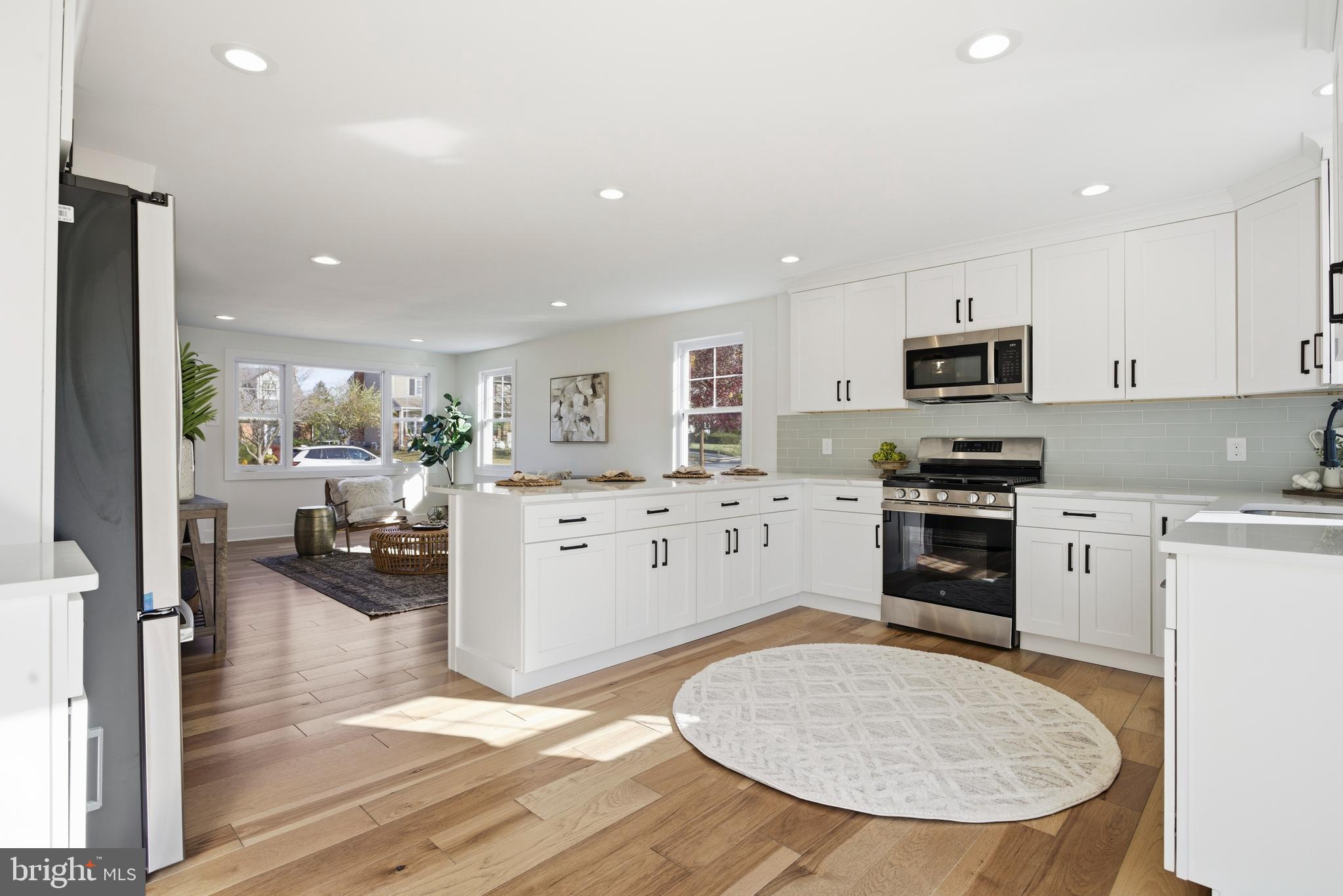 338 Wayne Avenue Springfield, PA 19064 - Photo 9 of 34 a kitchen with stainless steel appliances granite countertop a refrigerator stove microwave and sink