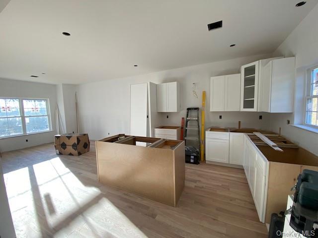 Lot #3 Mountain Road Port Jervis, NY 12771 - Photo 11 of 31 Kitchen featuring light hardwood / wood-style floors, white cabinetry, and a wealth of natural light