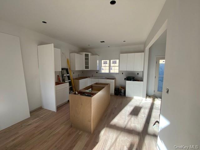 Lot #3 Mountain Road Port Jervis, NY 12771 - Photo 12 of 31 Kitchen featuring white cabinets, light hardwood / wood-style floors, and a kitchen island