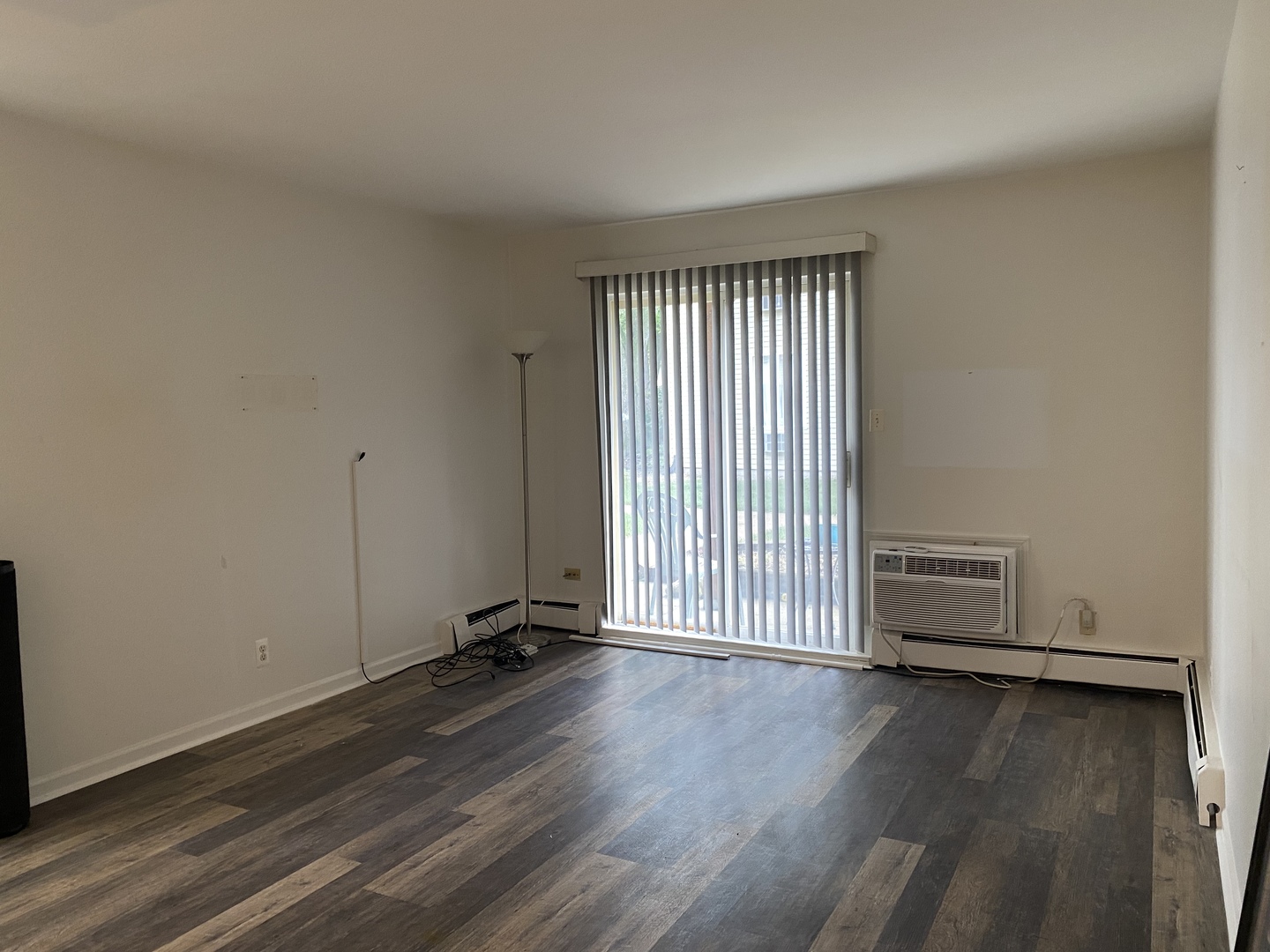 2600 Light Road, Unit 107 Oswego, IL 60543 - Photo 3 of 8 an empty room with wooden floor
