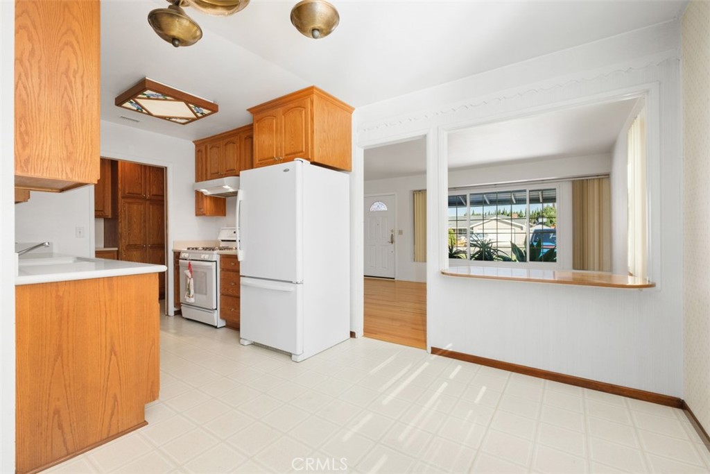 10221 Macduff Street Stanton, CA 90680 - Photo 12 of 31 a white refrigerator freezer sitting in a kitchen