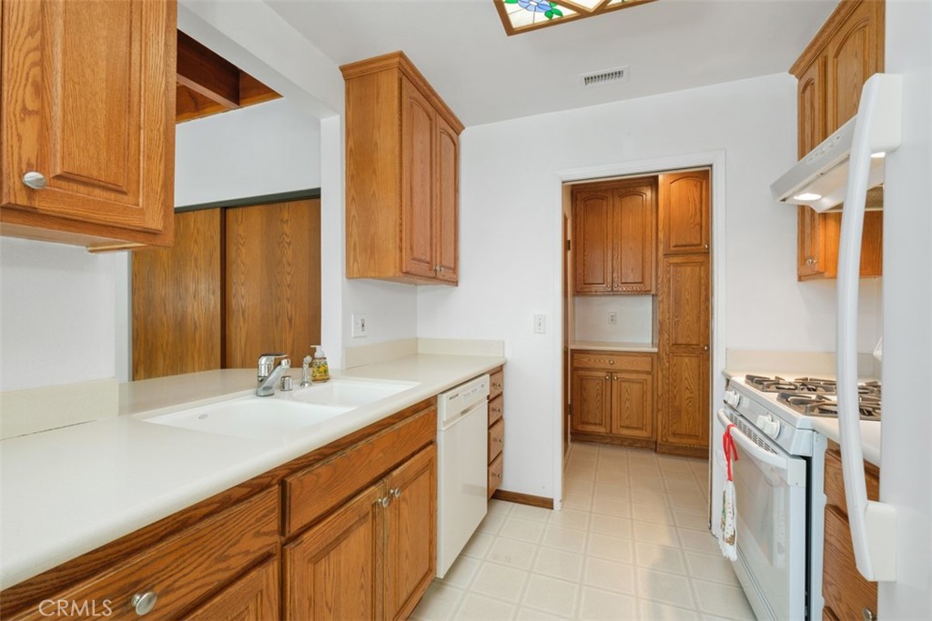 10221 Macduff Street Stanton, CA 90680 - Photo 14 of 31 a bathroom with a granite countertop sink and a mirror