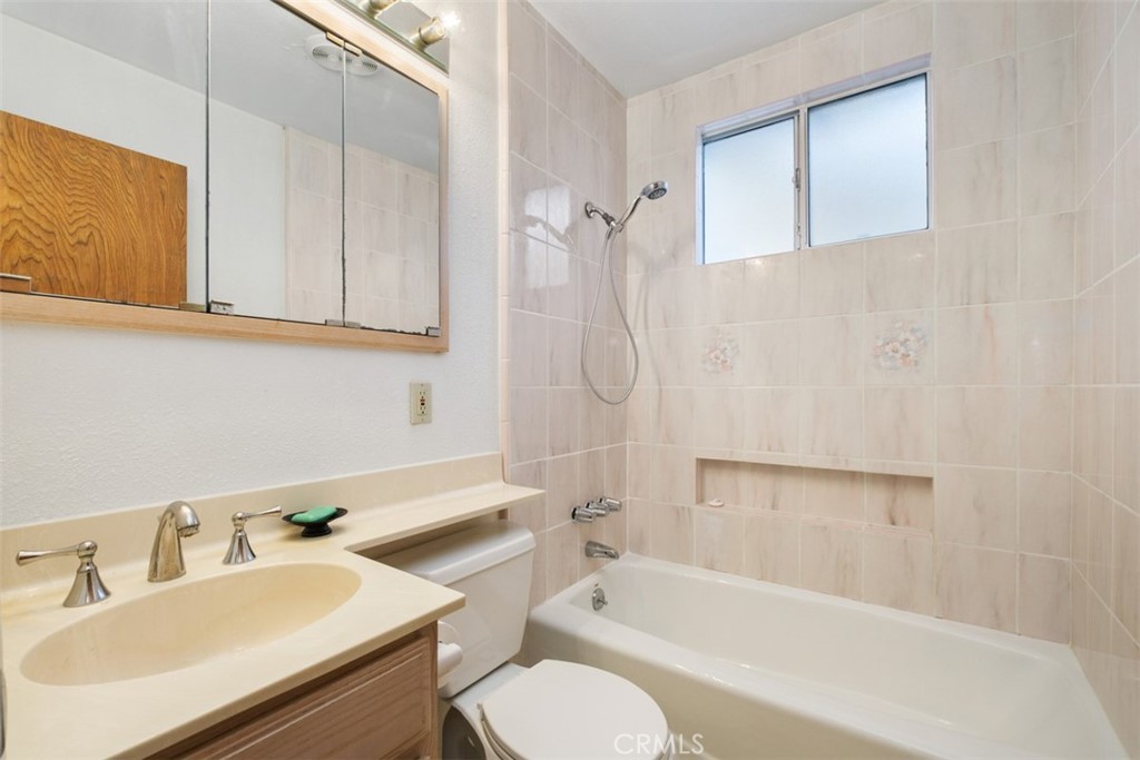 10221 Macduff Street Stanton, CA 90680 - Photo 21 of 31 a bathroom with a sink toilet vanity and bathtub