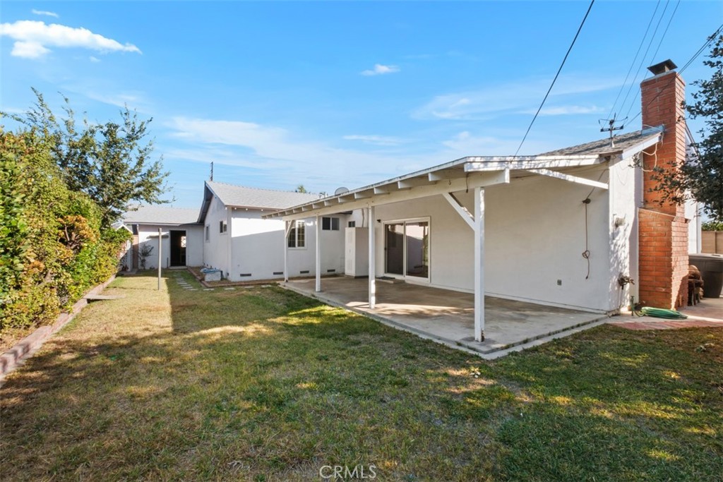 10221 Macduff Street Stanton, CA 90680 - Photo 30 of 31 a view of a house with backyard and garage