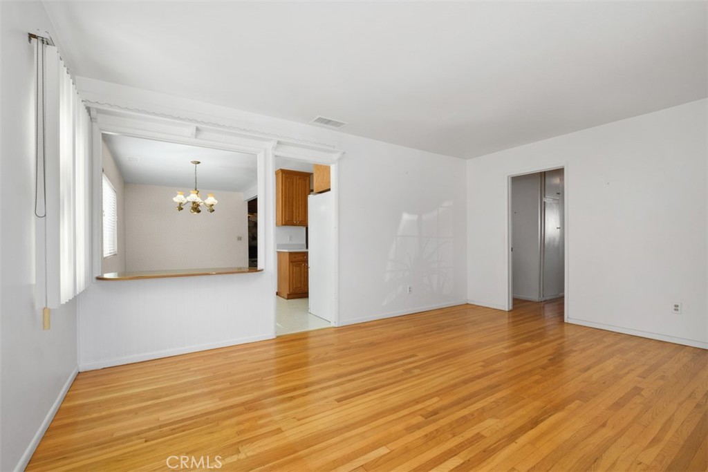 10221 Macduff Street Stanton, CA 90680 - Photo 8 of 31 a view of an empty room with wooden floor