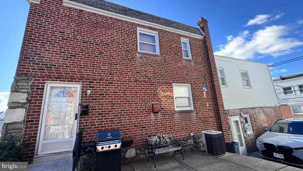 a brick building with a bench in front of it