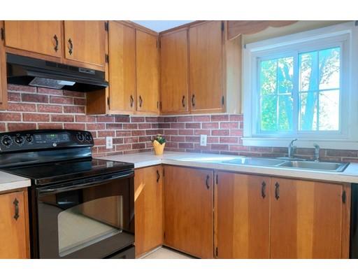 83 Lincoln Road Sutton, MA 01590 - Photo 8 of 22 a kitchen with granite countertop a stove sink and cabinets