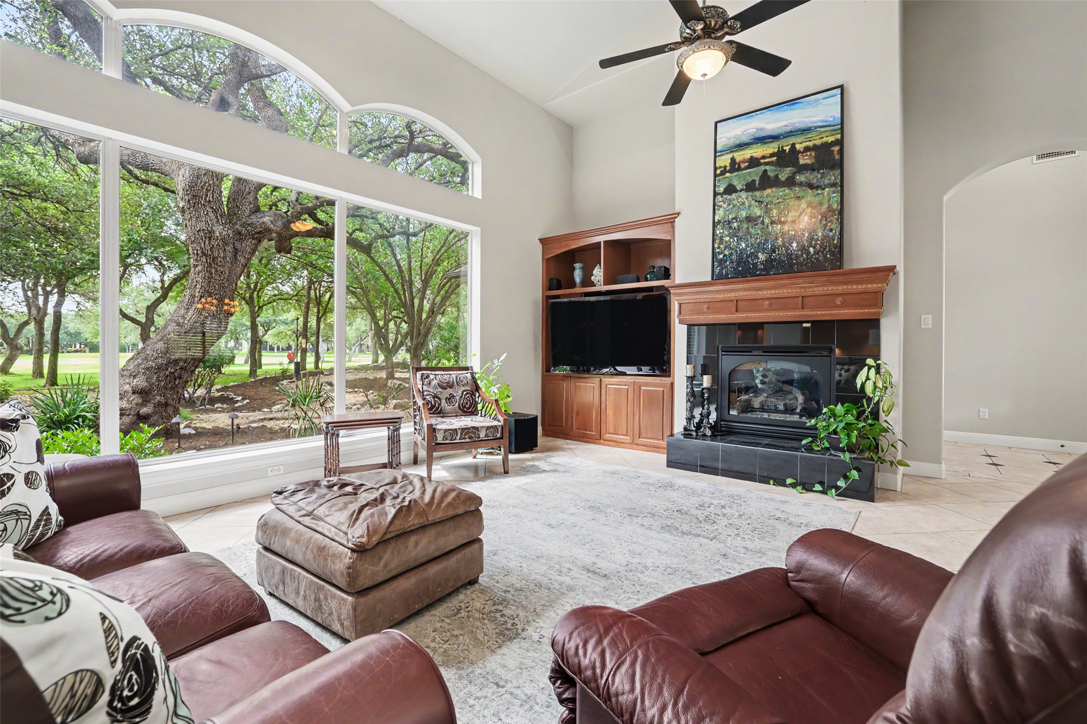 33 Meadows End Georgetown, TX 78628 - Photo 9 of 40 A spacious living area with tall ceilings and expansive windows offers natural light and serene views.