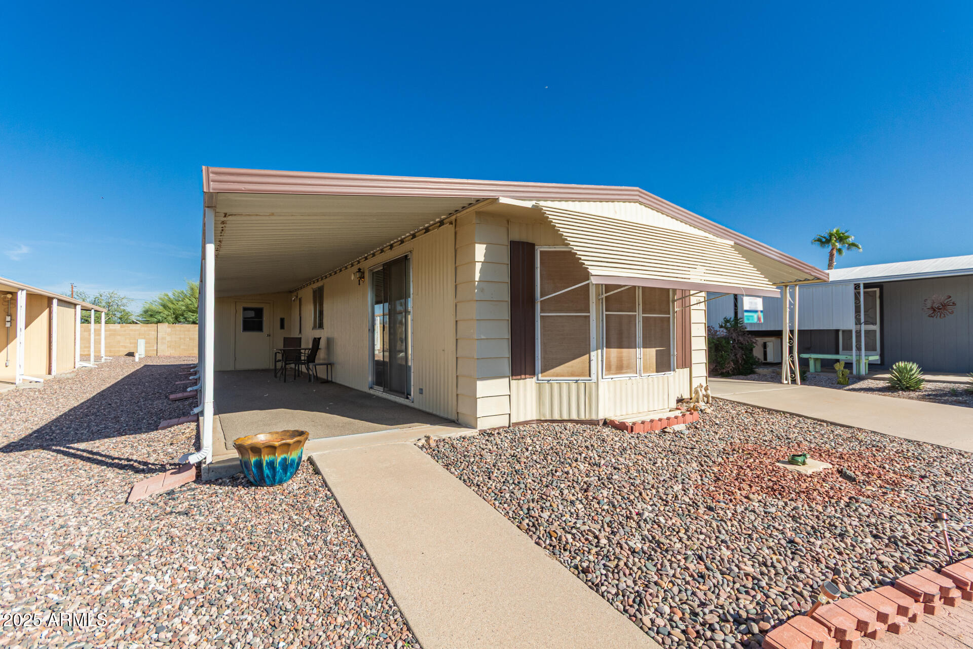 53 North Mountain Road, Unit 19 Apache Junction, AZ 85120 - Photo 1 of 21 a front view of a house with a yard