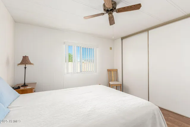 a bedroom with a large bed and a flat tv screen on dresser