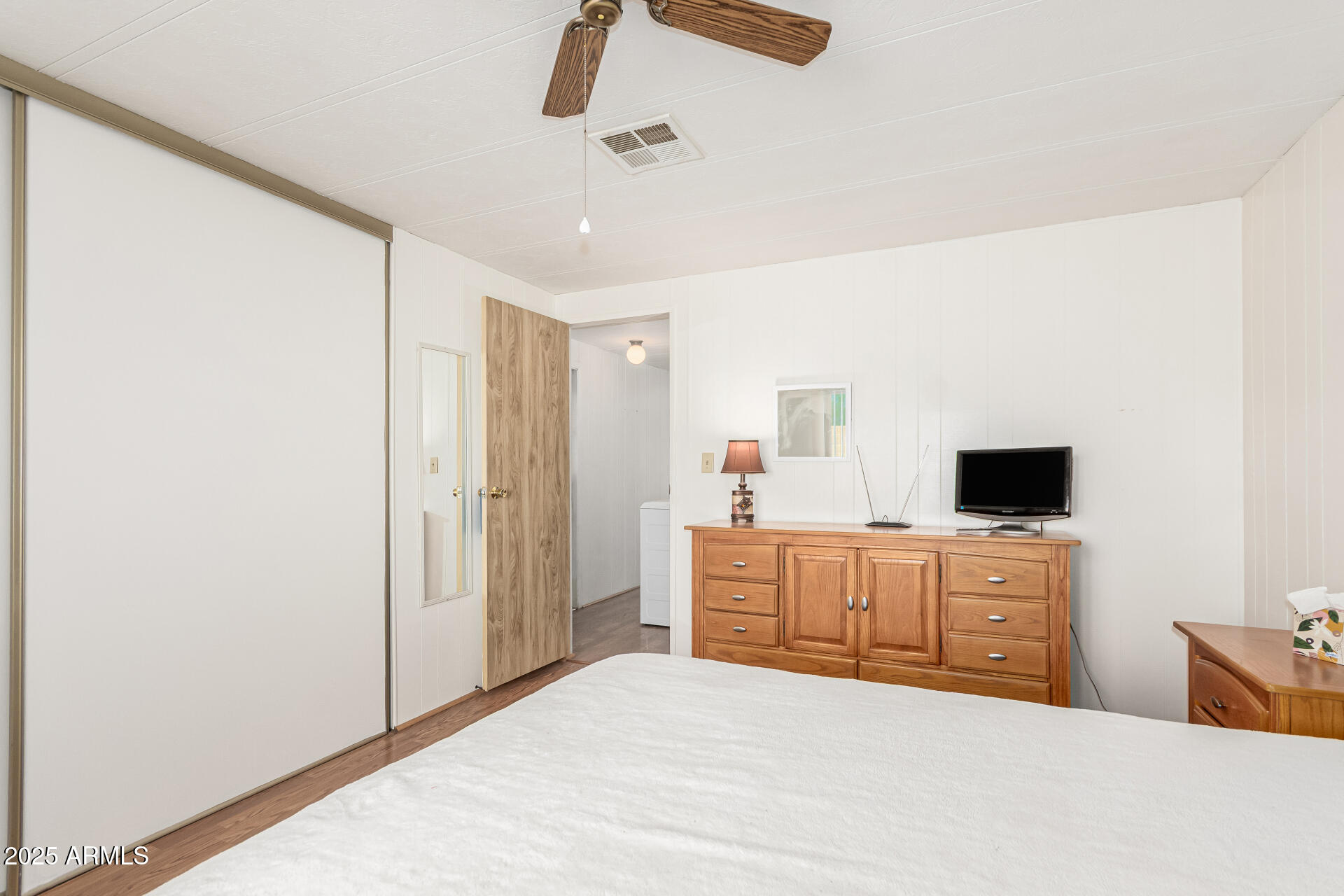 53 North Mountain Road, Unit 19 Apache Junction, AZ 85120 - Photo 14 of 21 a bedroom with a large bed and a flat tv screen on dresser