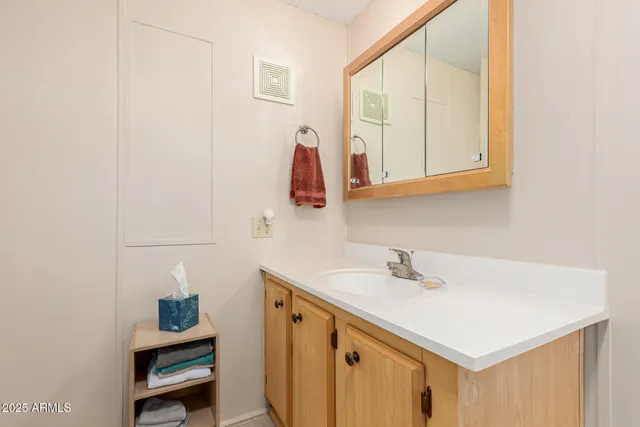 a patio with table and chairs and potted plants