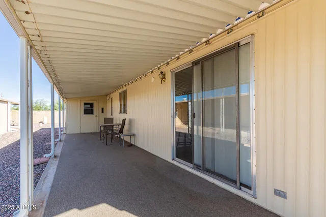 a view of a room that has a window and a chair