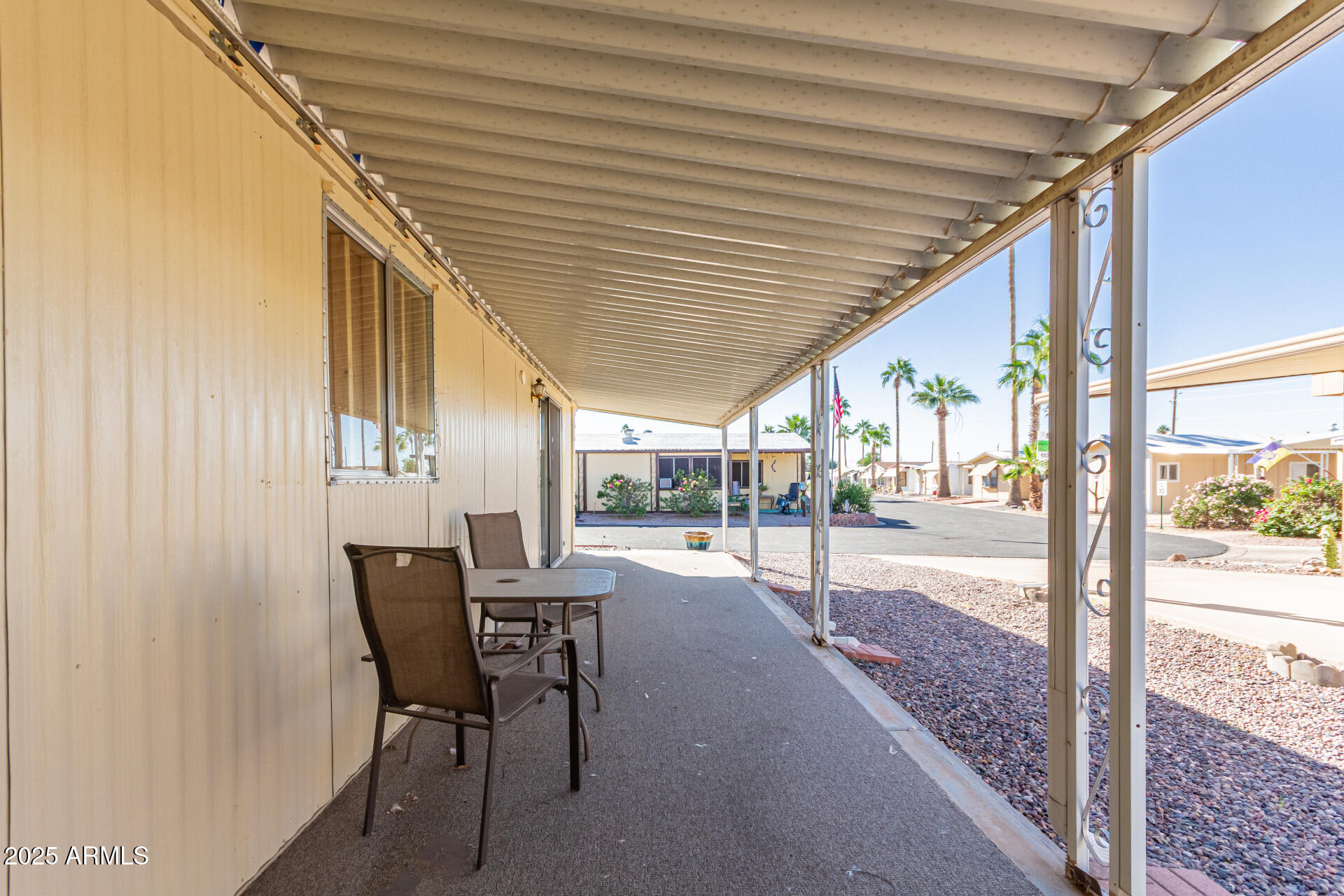 53 North Mountain Road, Unit 19 Apache Junction, AZ 85120 - Photo 18 of 21 a patio with table and chairs and potted plants