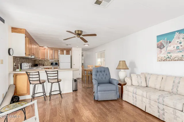 a living room with furniture and a kitchen view