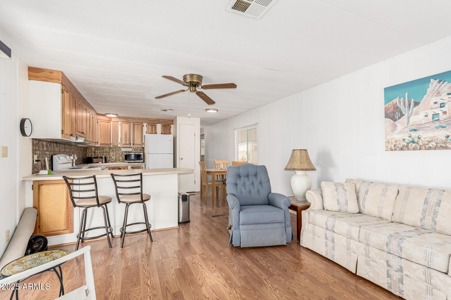 53 North Mountain Road, Unit 19 Apache Junction, AZ 85120 - Photo 5 of 21 a living room with furniture and a kitchen view
