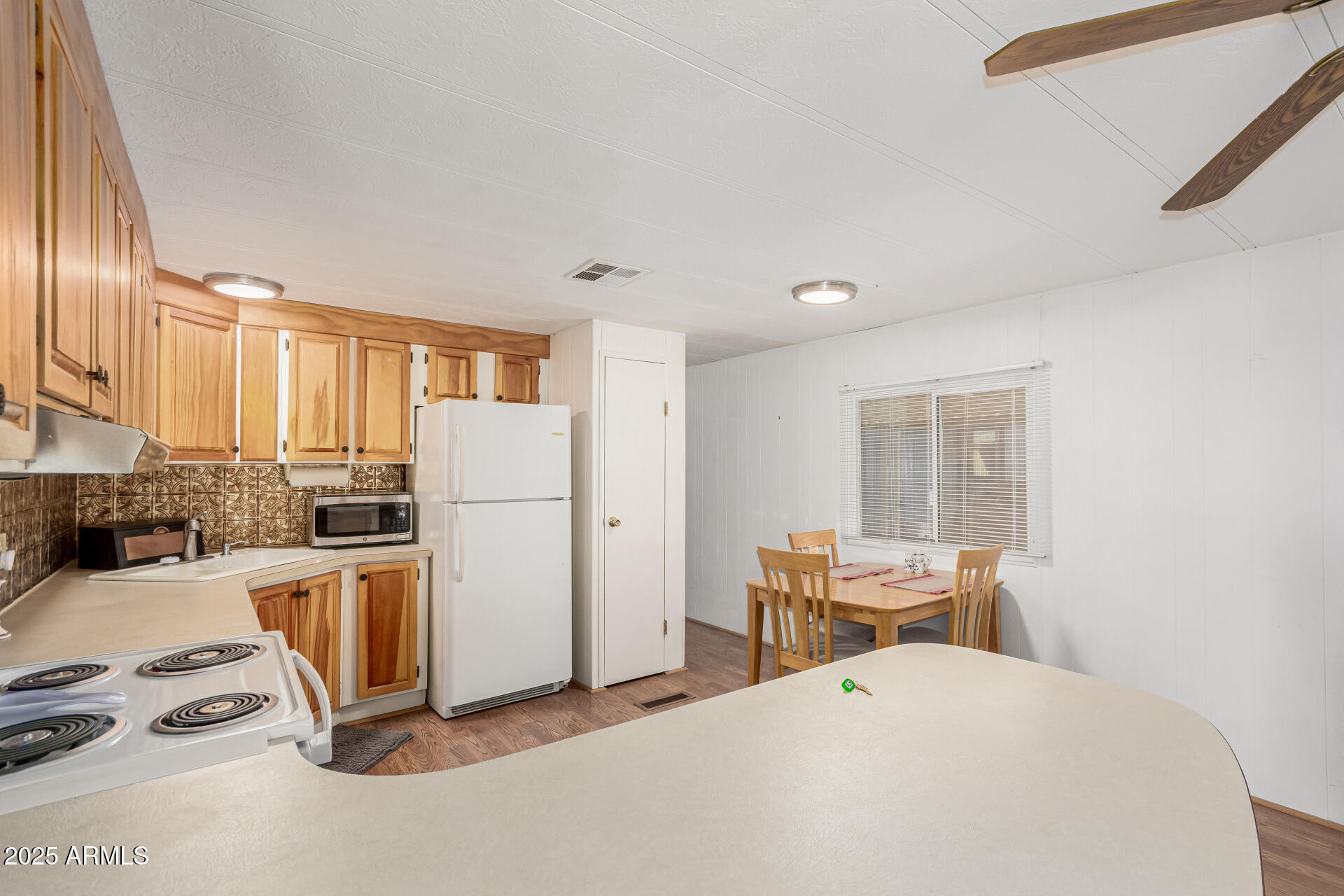 53 North Mountain Road, Unit 19 Apache Junction, AZ 85120 - Photo 9 of 21 a room with furniture a refrigerator and wooden floor