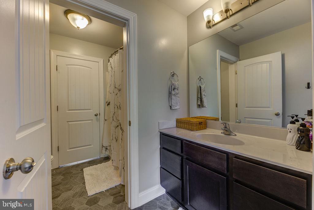 600 Ray Road Sunderland, MD 20689 - Photo 19 of 25 a bathroom with a shower sink and mirror