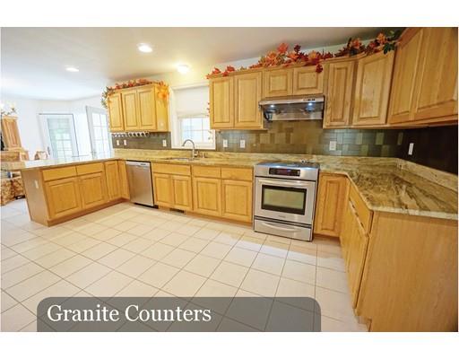93 Patten Hill Road Candia, NH 03034 - Photo 15 of 40 a kitchen with granite countertop a stove top oven and cabinets