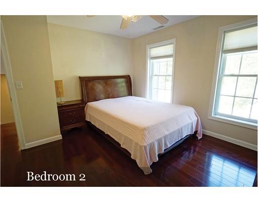 93 Patten Hill Road Candia, NH 03034 - Photo 32 of 40 a bedroom with a bed window and wooden floor