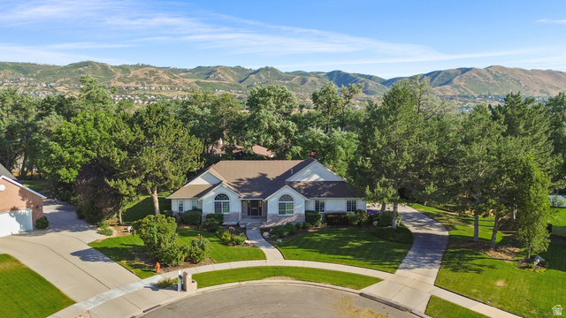 13357 Trail Rider Circle Draper, UT 84020 - Photo 60 of 70 Expansive property with a white exterior, brown shingle roof, and a mature tree canopy