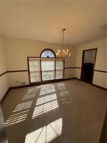a view of a livingroom with furniture and chandelier