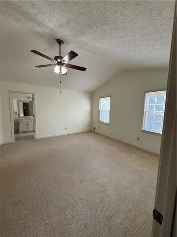 a view of a big room with chandelier fan and windows