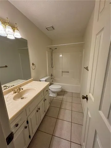 a bathroom with a sink mirror and shower