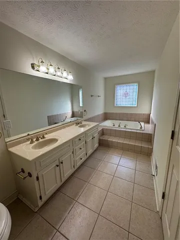 a utility room with a stove a sink and dishwasher