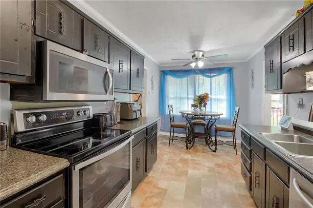 a kitchen with microwave a stove and cabinets