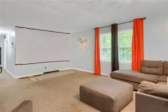 a living room with furniture and large window