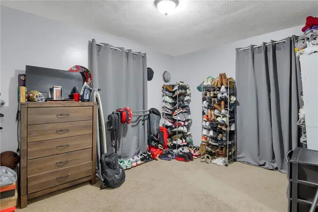 a view of walk in closet with clothes