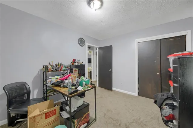 a living room with furniture and a gym machine