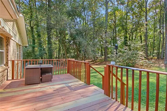 a view of a balcony with wooden floor and fence